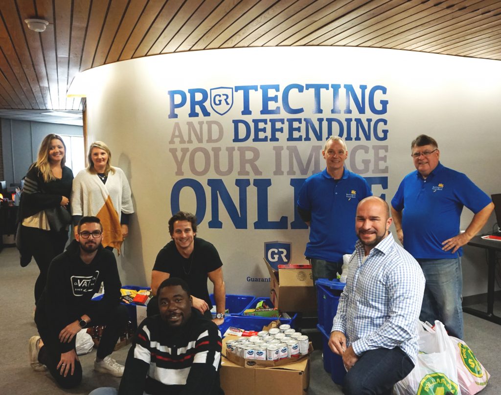 Guaranteed Removals employees with food drive donations