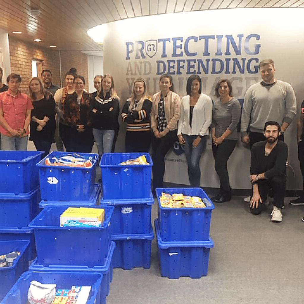 Guaranteed Removals staff with food drive donations in bins