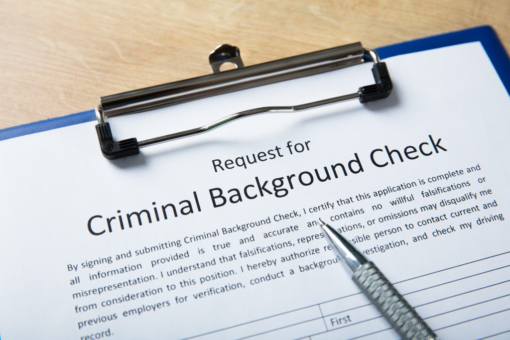 High Angel View Of Criminal Background Check Application Form With Pen