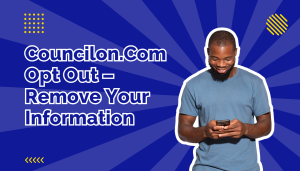 man in blue t-shirt smiling and looking at cell phone