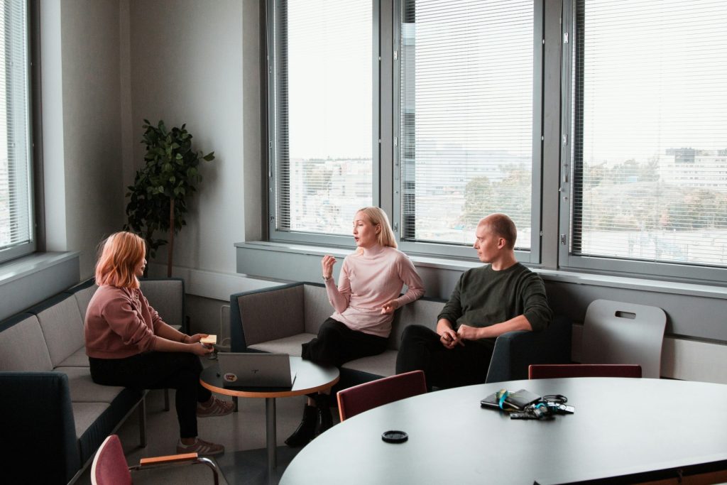 three people talking in an office