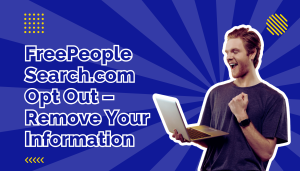 Man in purple t-shirt holding silver laptop